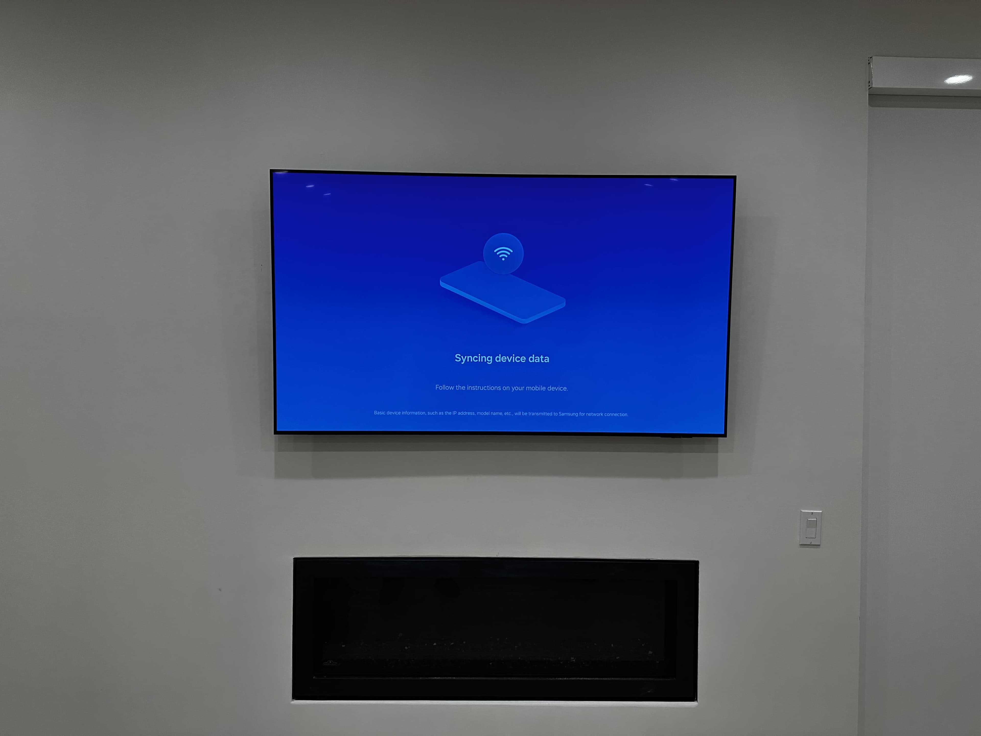 TV mounted above a modern fireplace