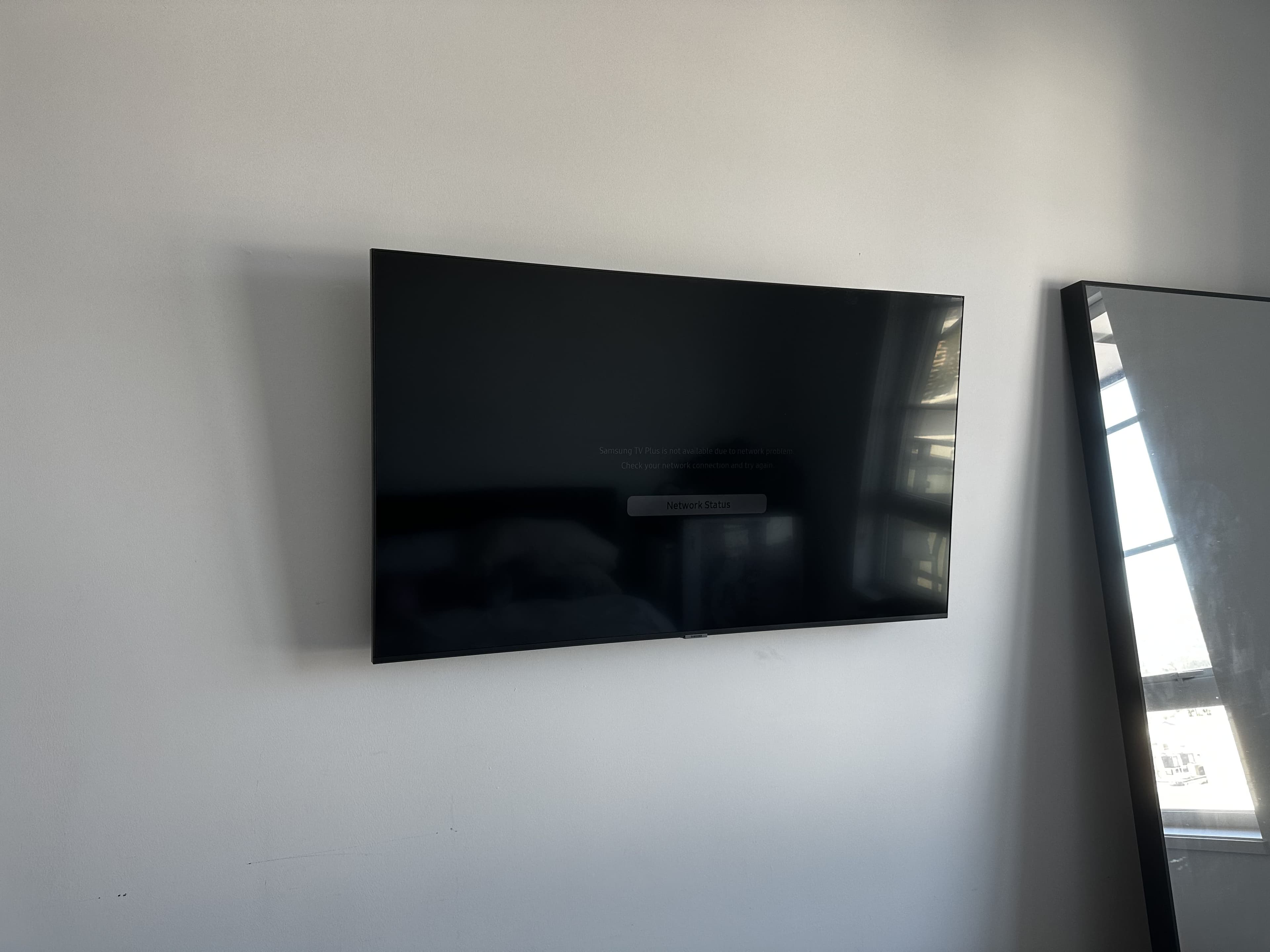 Slim TV installation in a bright room