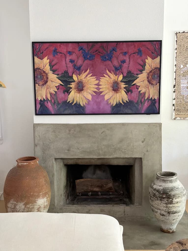 TV mounted above a modern fireplace
