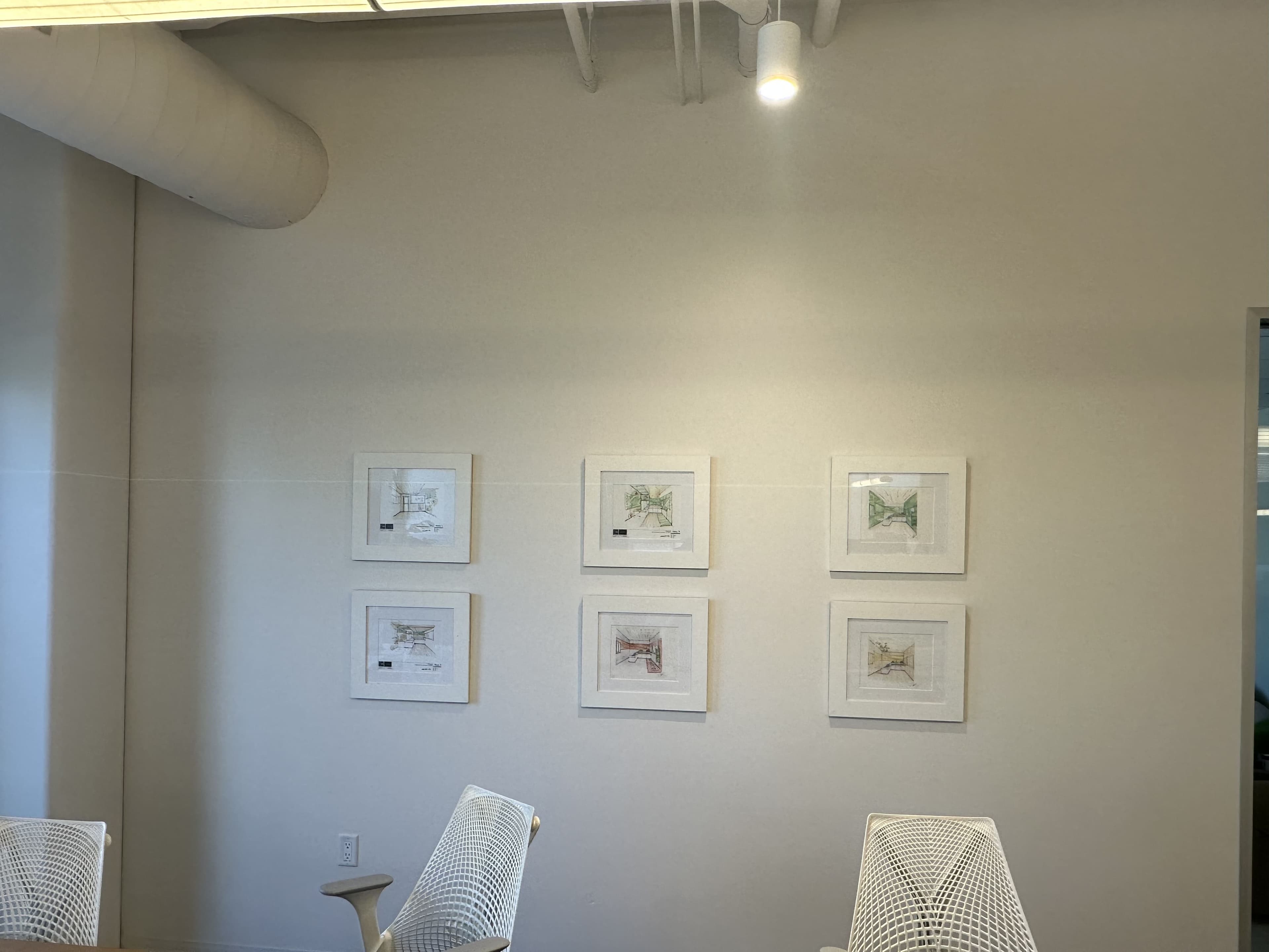 Completed gallery wall with framed art installed level and evenly spaced
