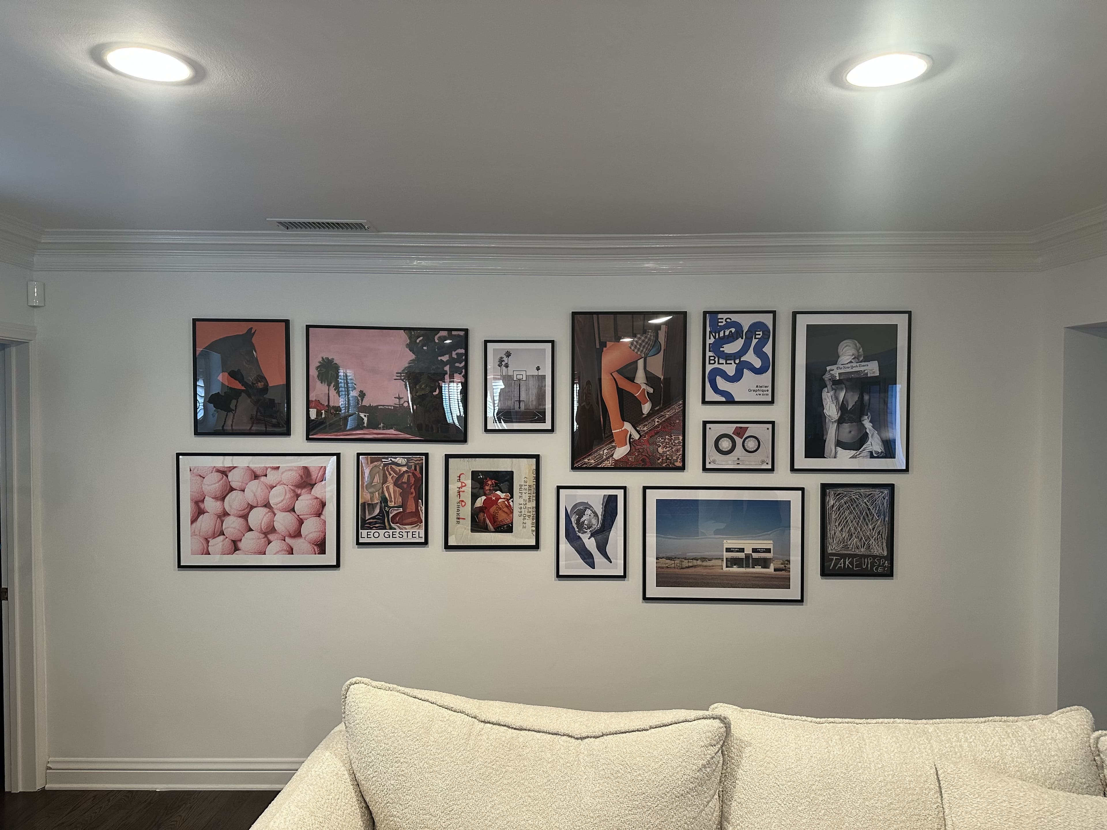 Completed gallery wall with framed art installed level and evenly spaced