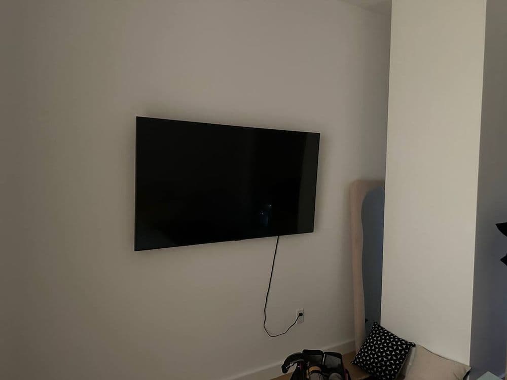 TV mounted above a fireplace