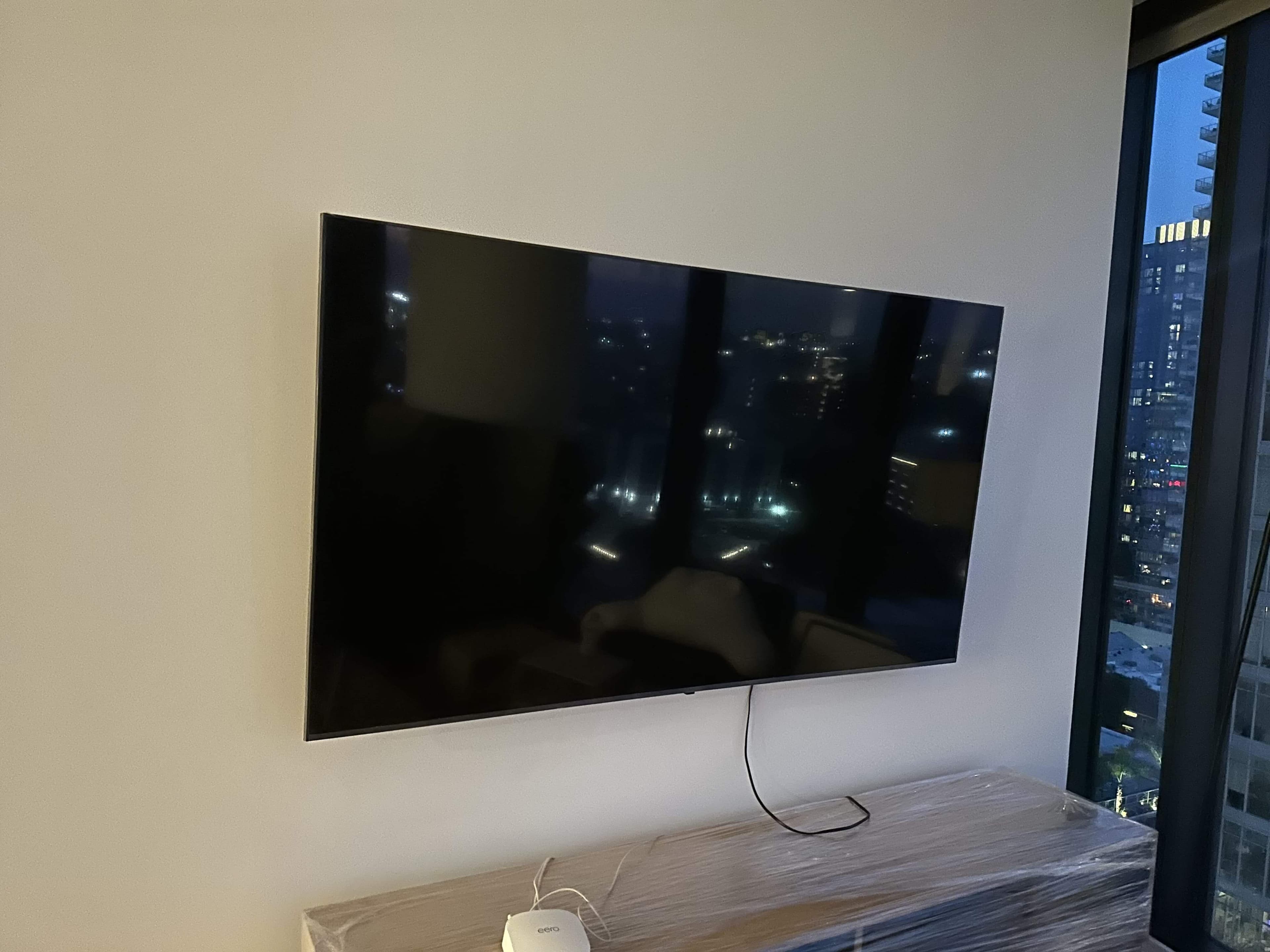 Wall-mounted TV with a clean entertainment setup