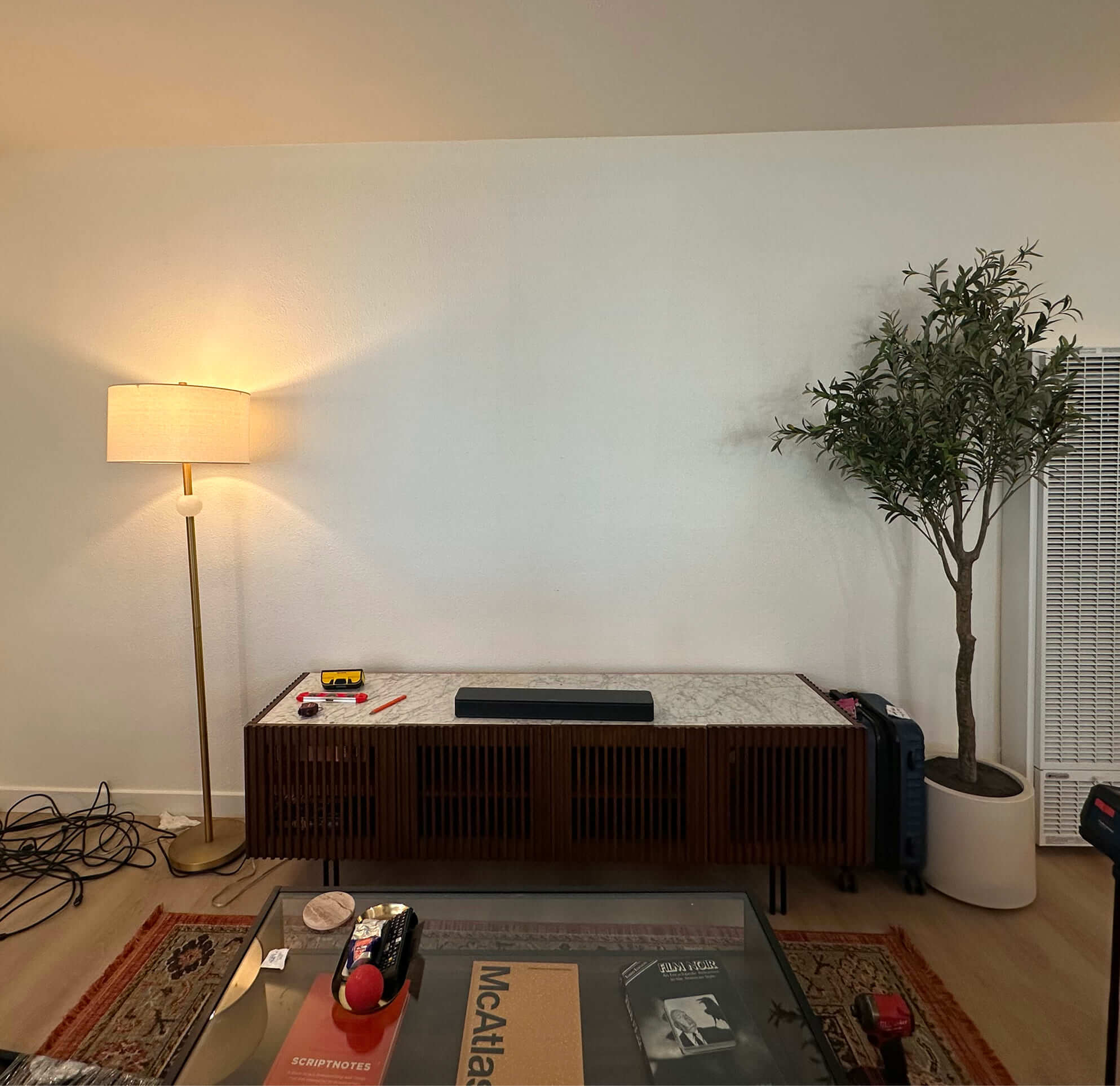 TV mounting before in-wall cable concealment with visible wires